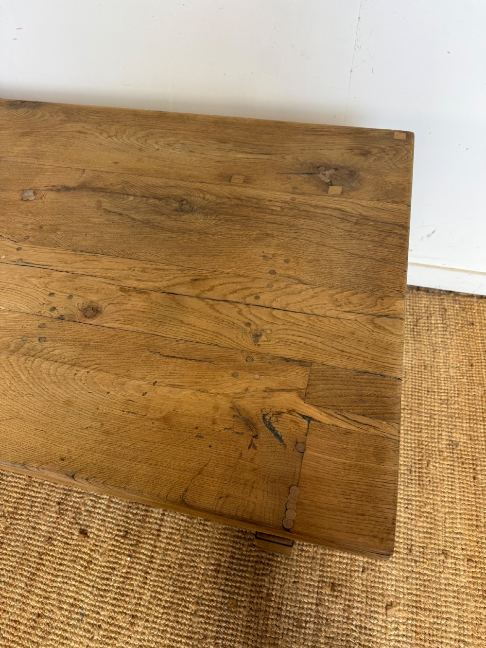 A long rectangular scrubbed oak refectory table featuring a solid top and trestle base with a low central stretcher. View VIII