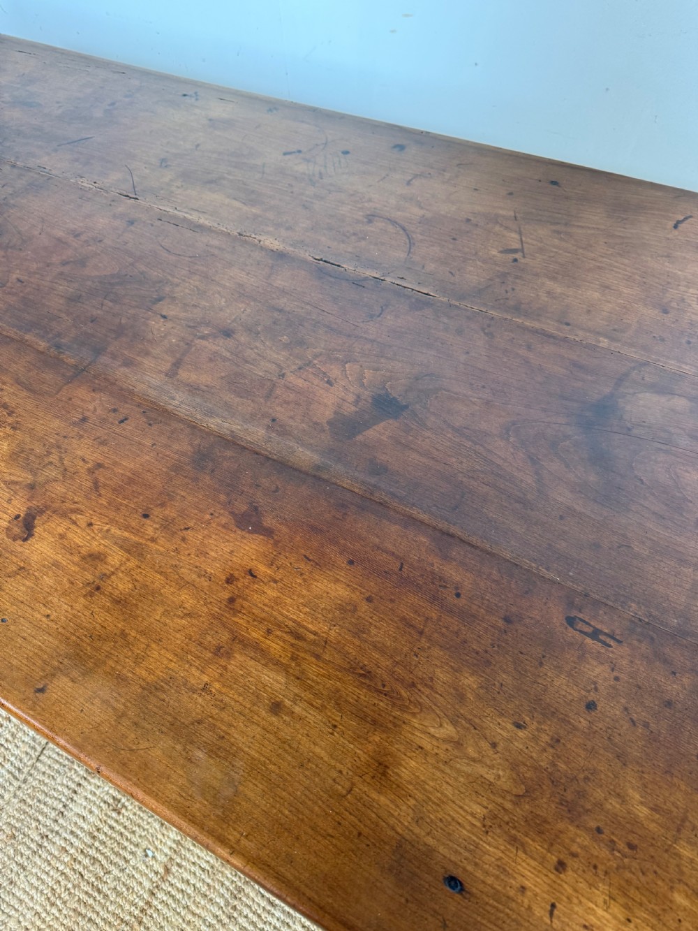 An antique French cherrywood farmhouse dining table featuring a plank top, single frieze drawer, and four square tapered legs. View VIII