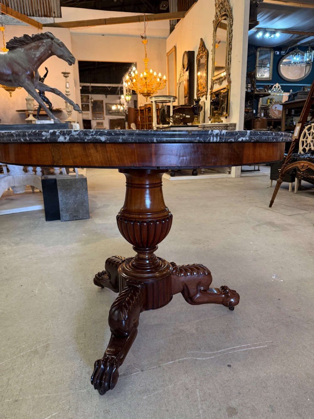 A 19th-century circular centre table featuring a dark veined marble top supported by a carved mahogany pedestal stem and a tripartite claw-foot base. View III