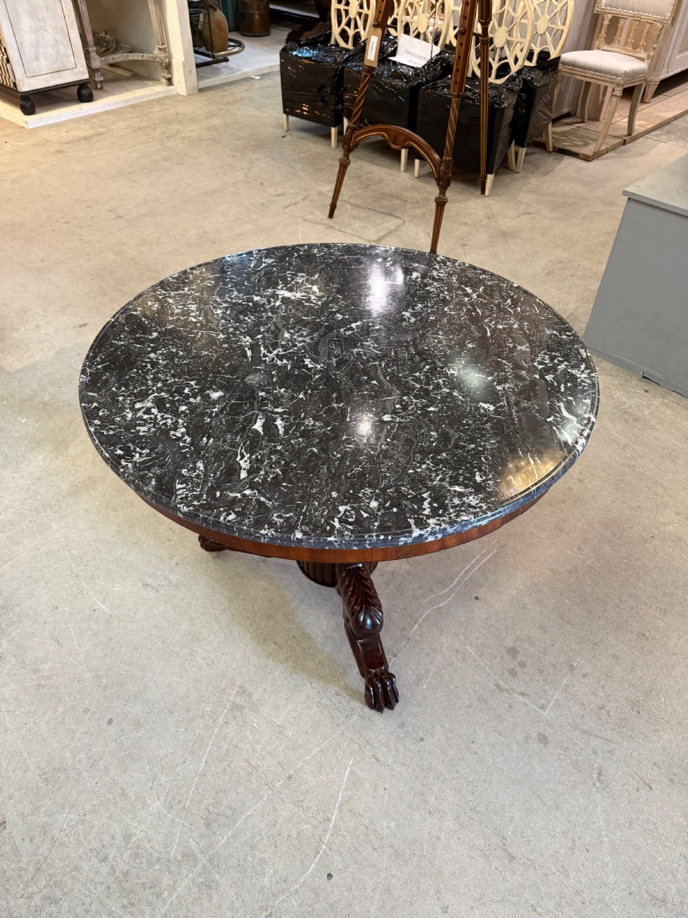 A 19th-century circular centre table featuring a dark veined marble top supported by a carved mahogany pedestal stem and a tripartite claw-foot base. View VI