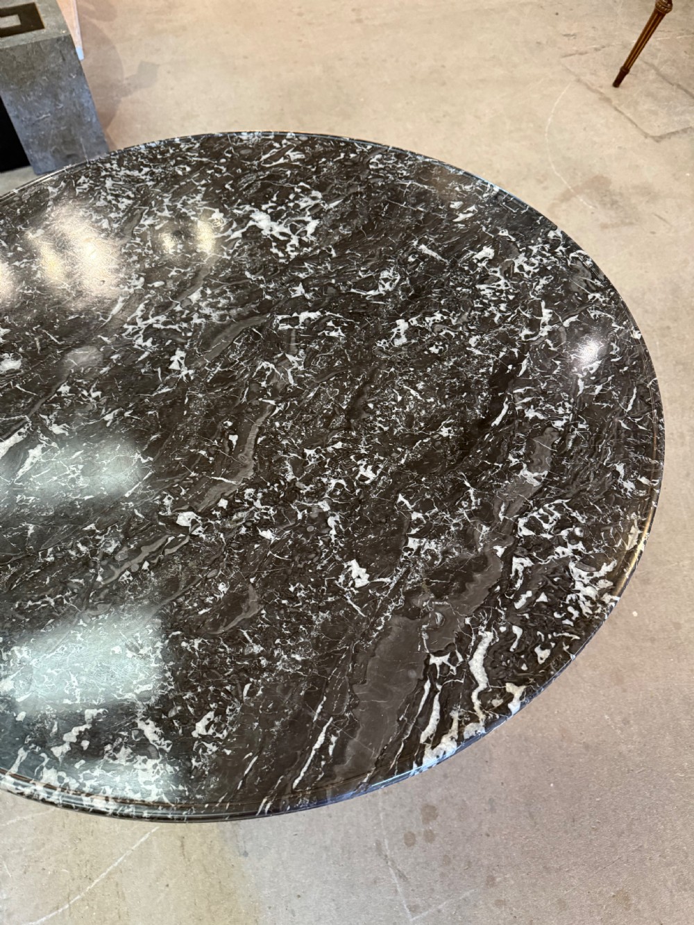 A 19th-century circular centre table featuring a dark veined marble top supported by a carved mahogany pedestal stem and a tripartite claw-foot base. View VII