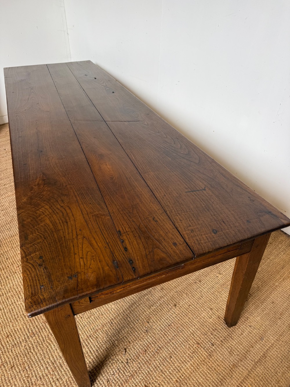 A three metre long antique oak farmhouse table featuring a three-plank top and straight tapered square legs. View II