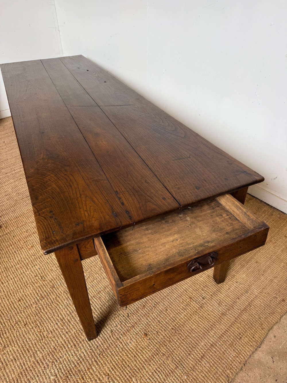 A three metre long antique oak farmhouse table featuring a three-plank top and straight tapered square legs. View III
