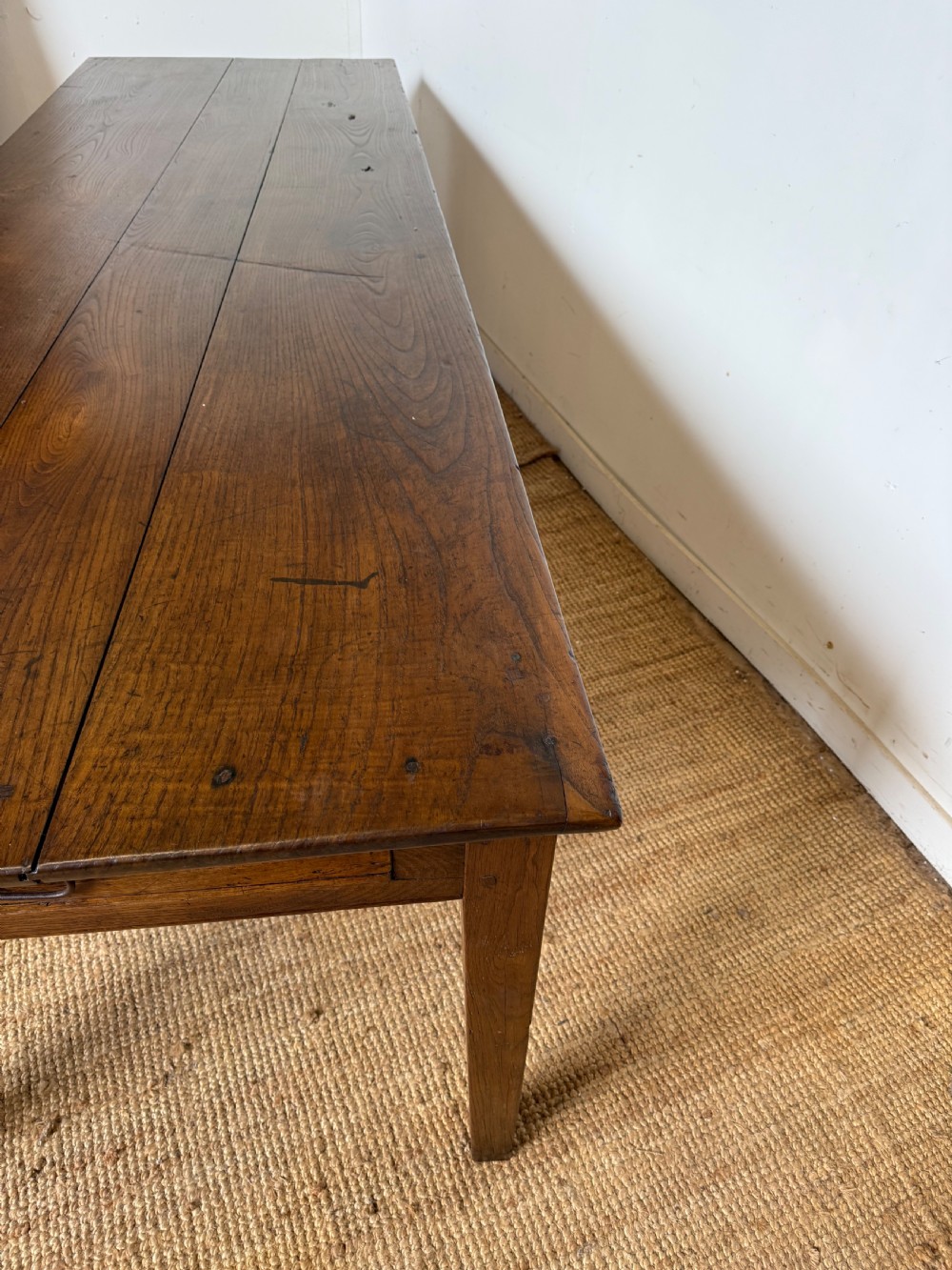 A three metre long antique oak farmhouse table featuring a three-plank top and straight tapered square legs. View IV