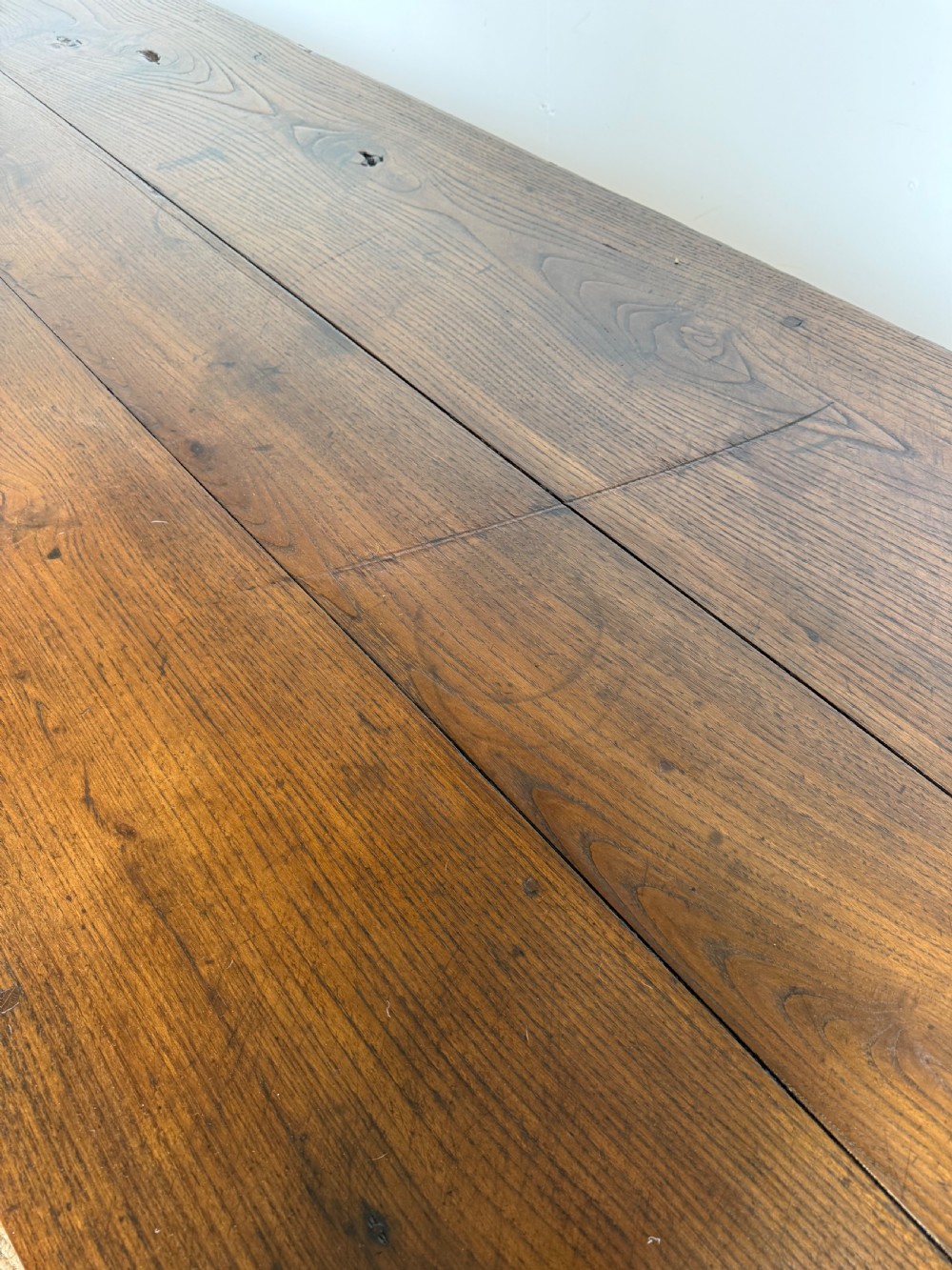 A three metre long antique oak farmhouse table featuring a three-plank top and straight tapered square legs. View VII