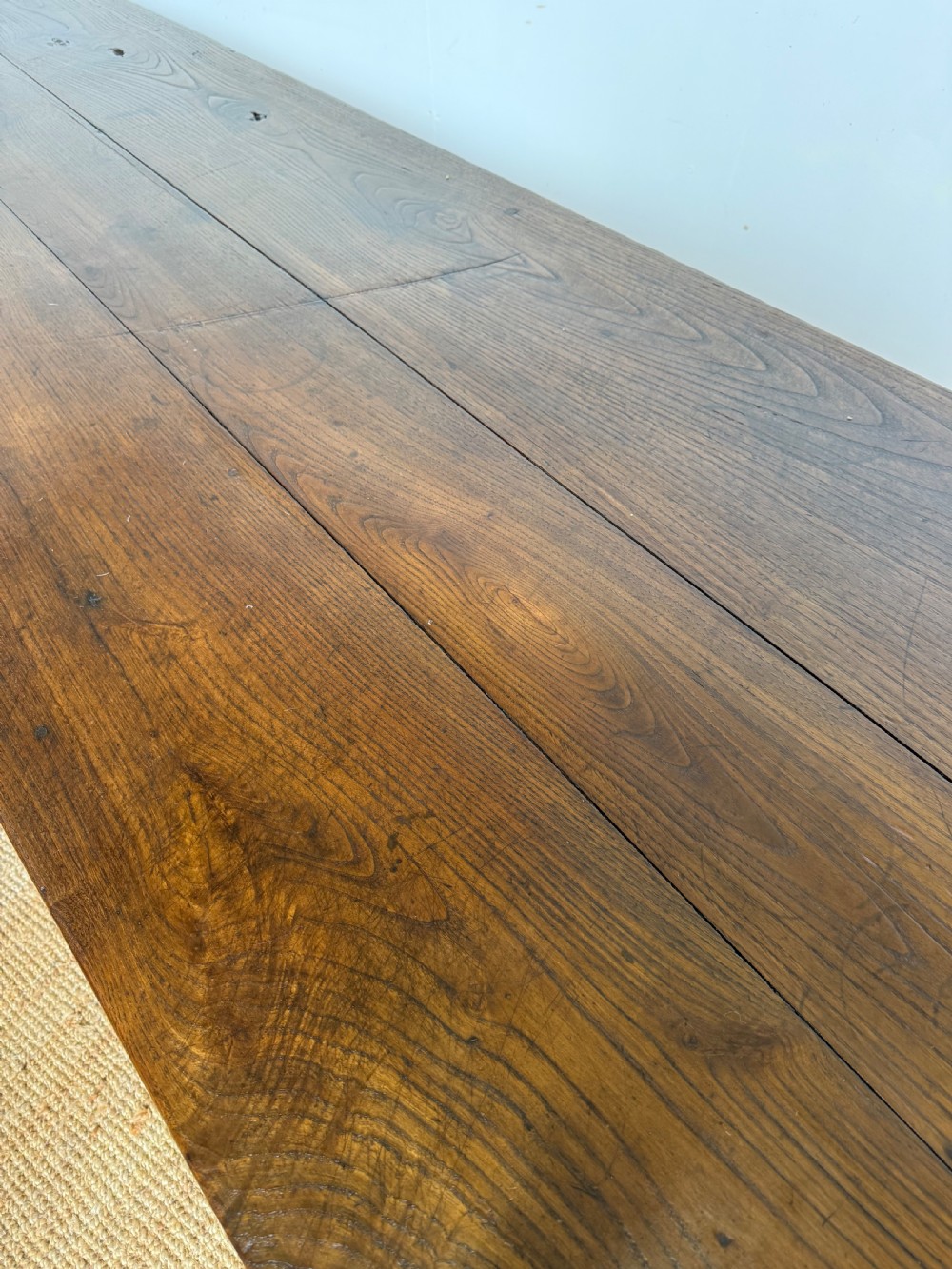 A three metre long antique oak farmhouse table featuring a three-plank top and straight tapered square legs. View VIII