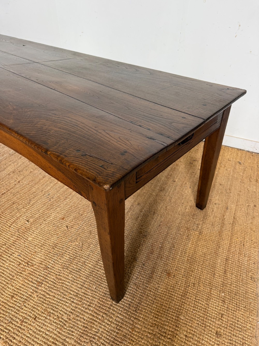 A three metre long antique oak farmhouse table featuring a three-plank top and straight tapered square legs. View IX