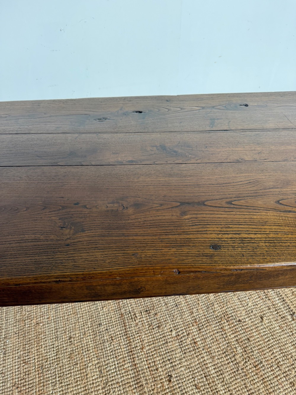 A three metre long antique oak farmhouse table featuring a three-plank top and straight tapered square legs. View X