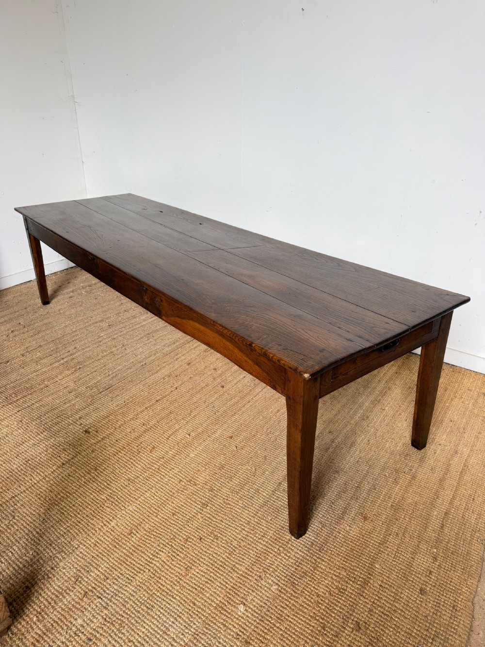 A three metre long antique oak farmhouse table featuring a three-plank top and straight tapered square legs. View XIV