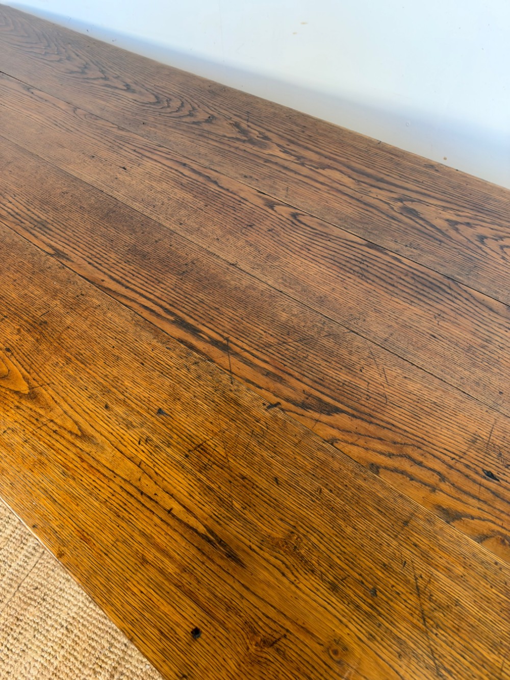 A large late nineteenth-century solid oak farmhouse dining table featuring a plank top with rounded corners and four straight legs. View VI