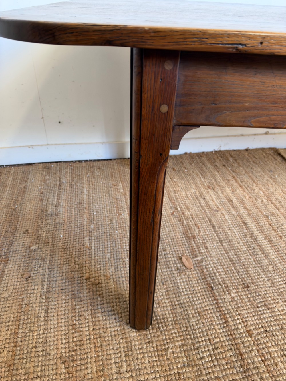 A large late nineteenth-century solid oak farmhouse dining table featuring a plank top with rounded corners and four straight legs. View VIII