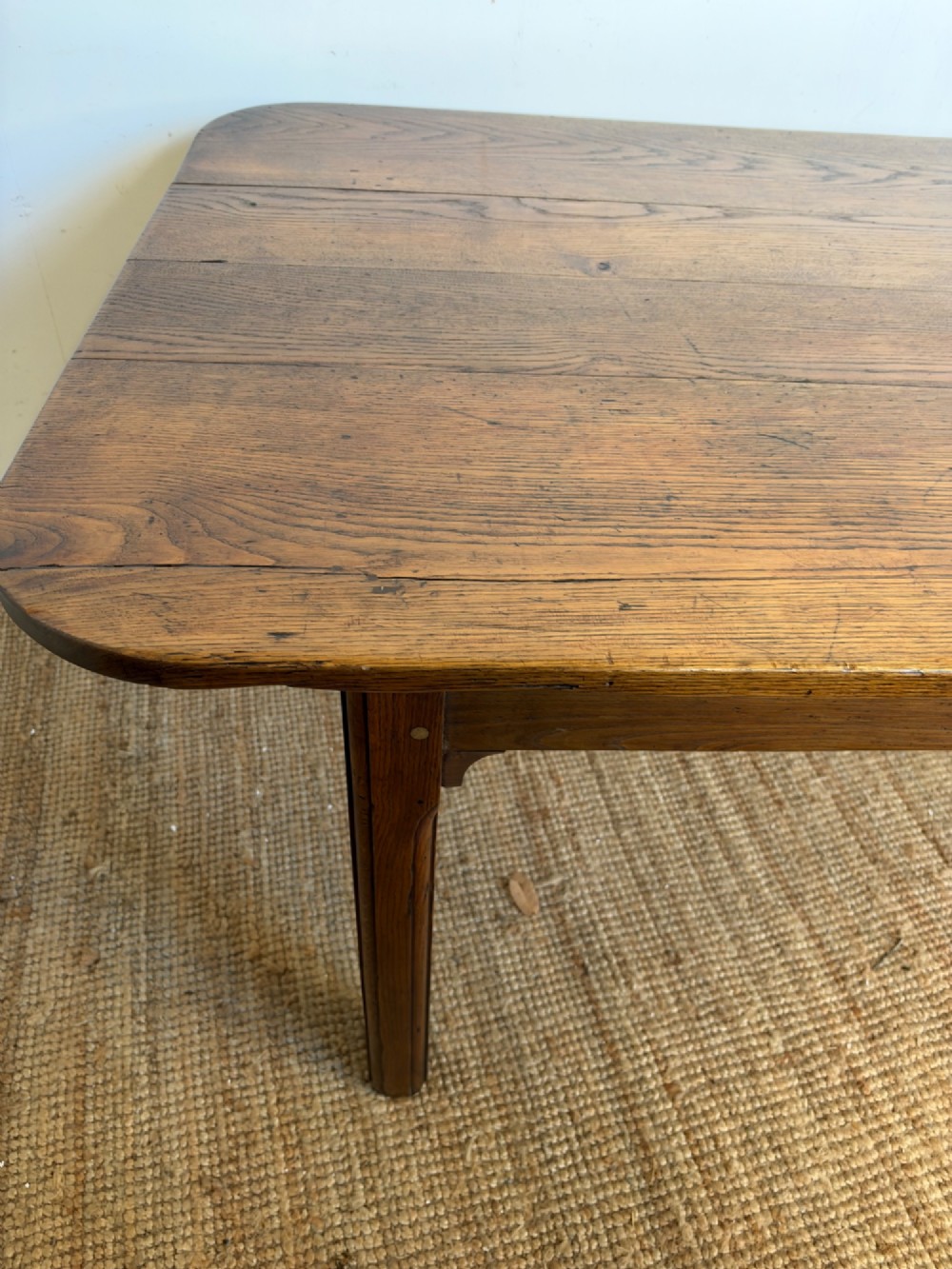 A large late nineteenth-century solid oak farmhouse dining table featuring a plank top with rounded corners and four straight legs. View IX
