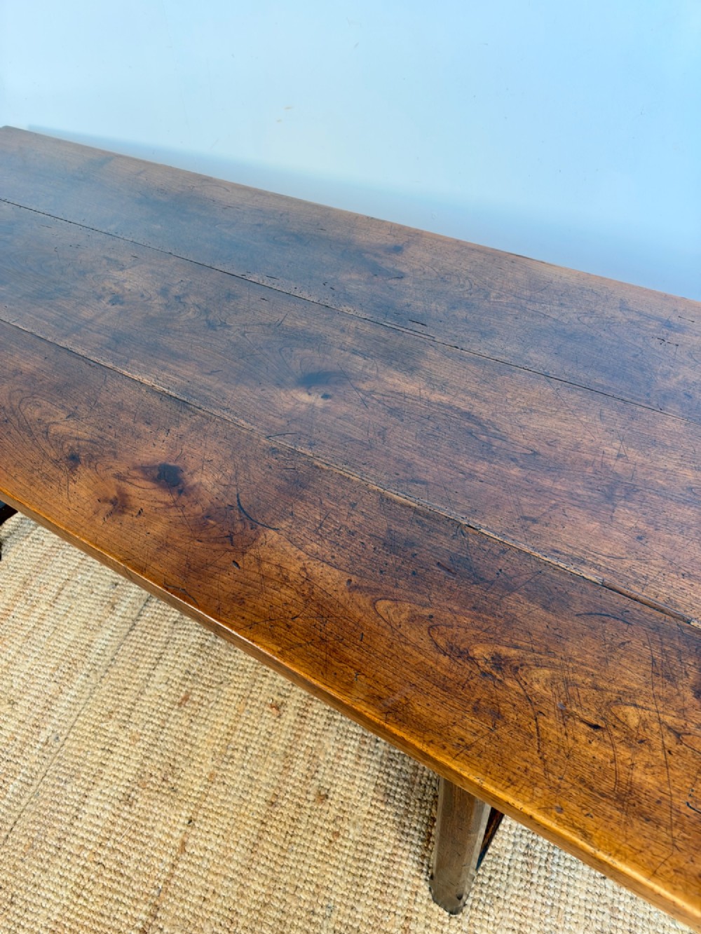 A rustic rectangular cherrywood farmhouse dining table with a three-plank top and an H-stretcher base. View III