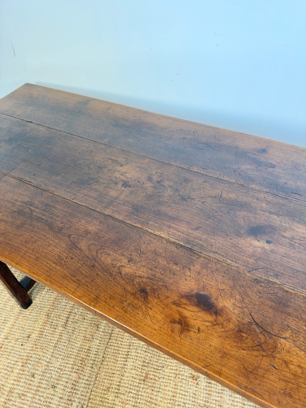 A rustic rectangular cherrywood farmhouse dining table with a three-plank top and an H-stretcher base. View IV
