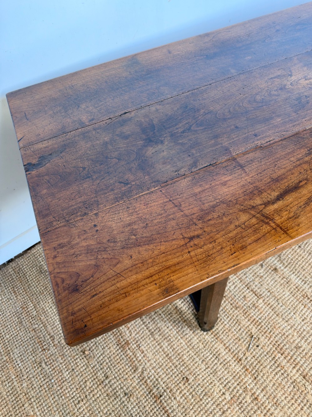 A rustic rectangular cherrywood farmhouse dining table with a three-plank top and an H-stretcher base. View V