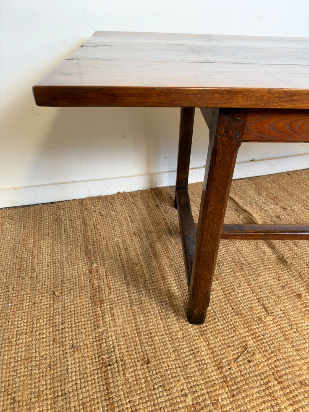 A rustic rectangular cherrywood farmhouse dining table with a three-plank top and an H-stretcher base. View VI