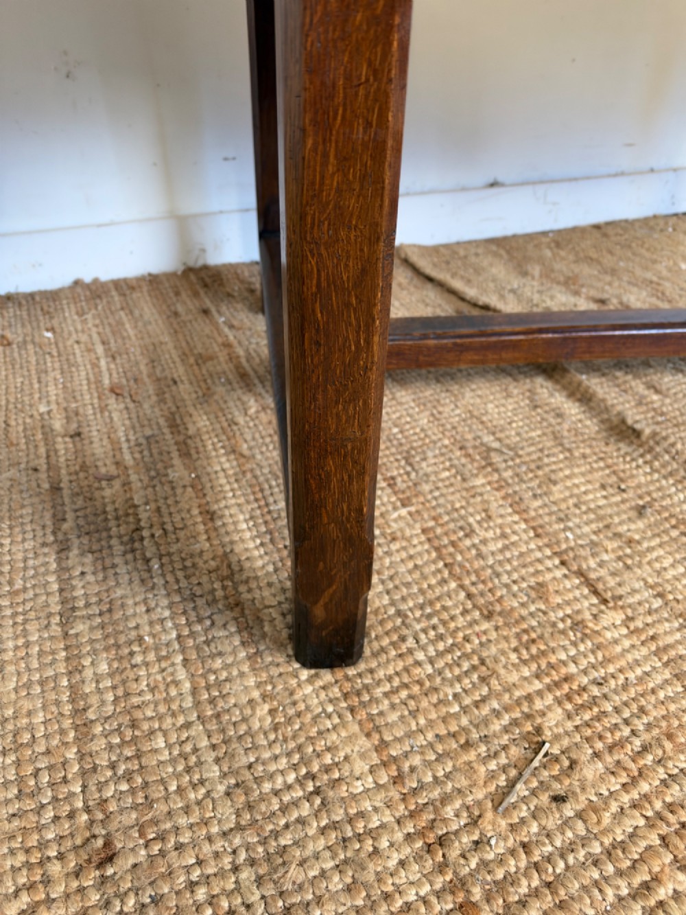 A rustic rectangular cherrywood farmhouse dining table with a three-plank top and an H-stretcher base. View VII