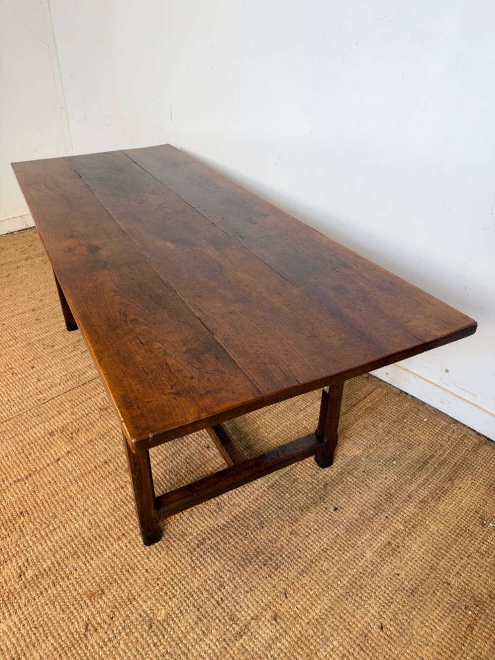 A rustic rectangular cherrywood farmhouse dining table with a three-plank top and an H-stretcher base. View IX