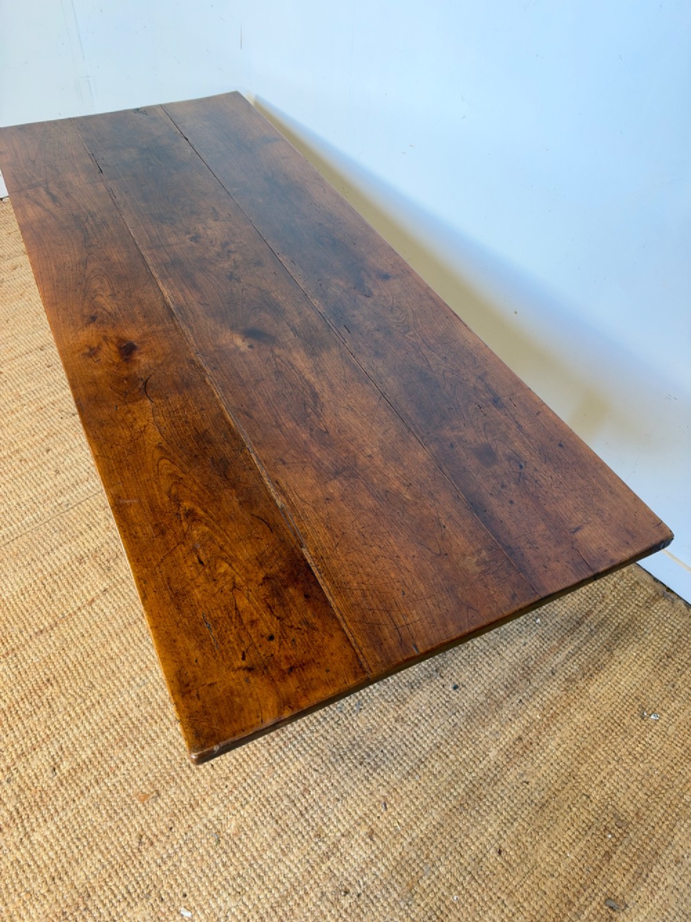 A rustic rectangular cherrywood farmhouse dining table with a three-plank top and an H-stretcher base. View X