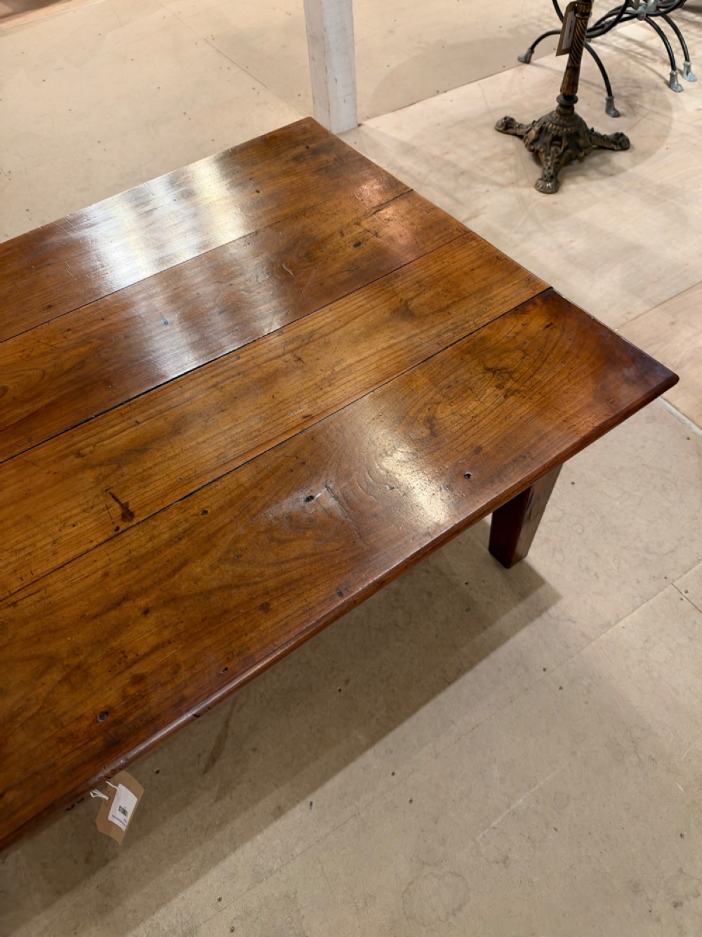 A large rectangular warm brown cherrywood coffee table featuring a plank top, tapered square legs, and a small drawer with a ring pull handle. View V