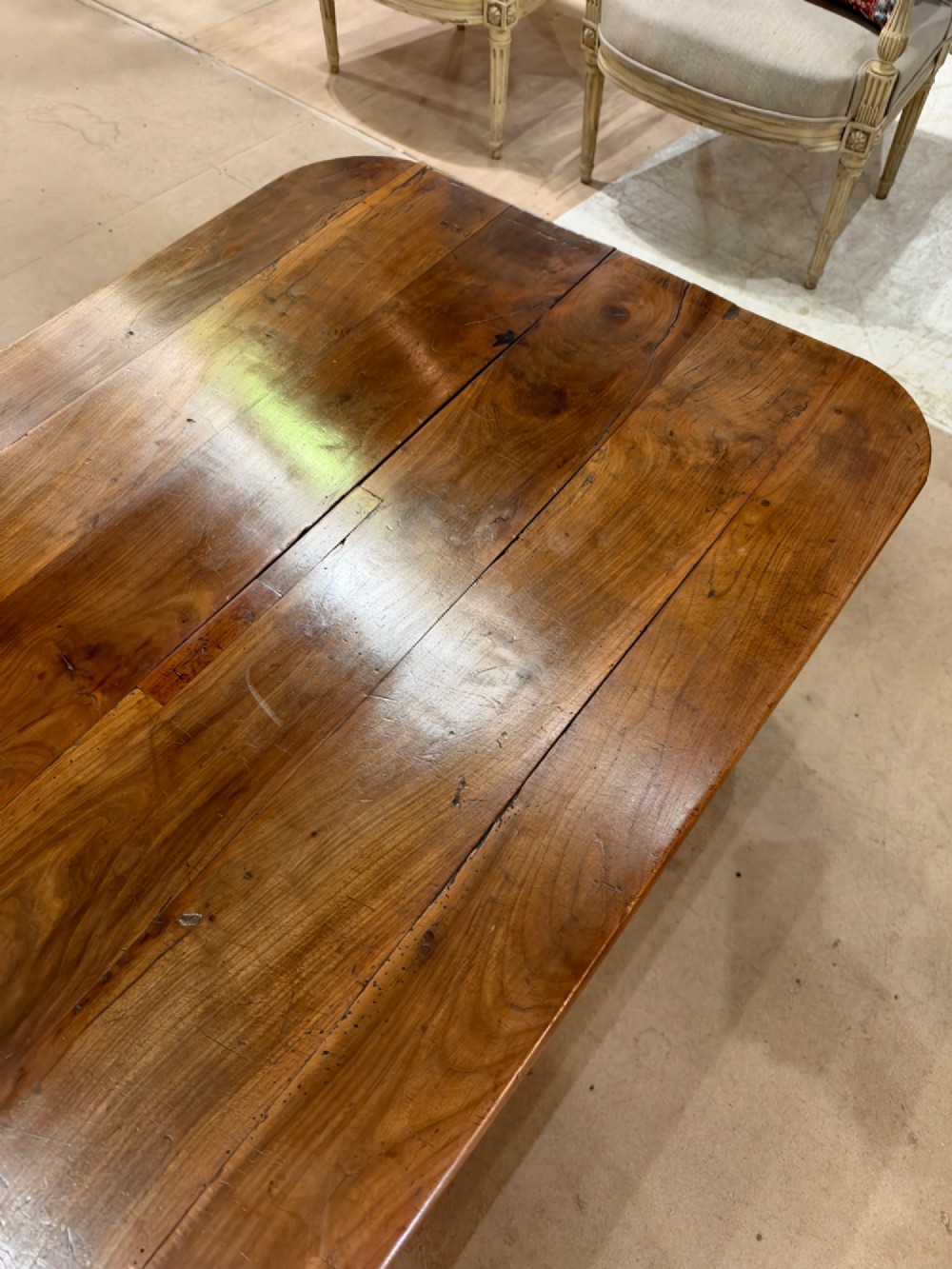 A low rectangular cherrywood coffee table featuring a plank top with rounded corners, tapered square legs, and a small side drawer. View IV