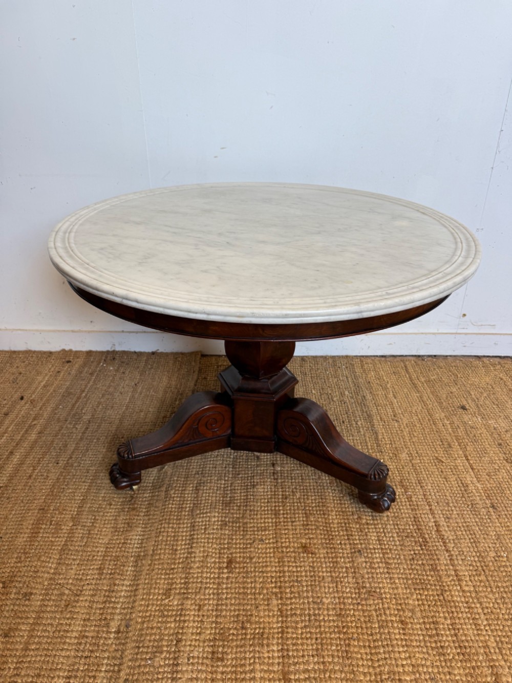A 19th-century circular centre table featuring a white marble top set on a dark mahogany turned pedestal with a scroll-footed tripod base. View II
