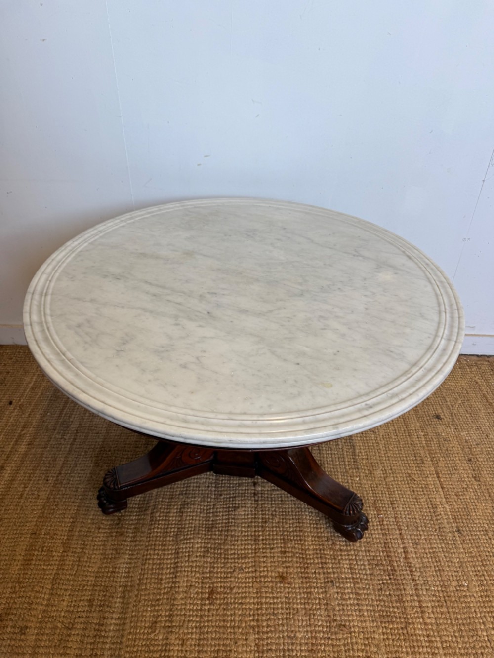 A 19th-century circular centre table featuring a white marble top set on a dark mahogany turned pedestal with a scroll-footed tripod base. View VI
