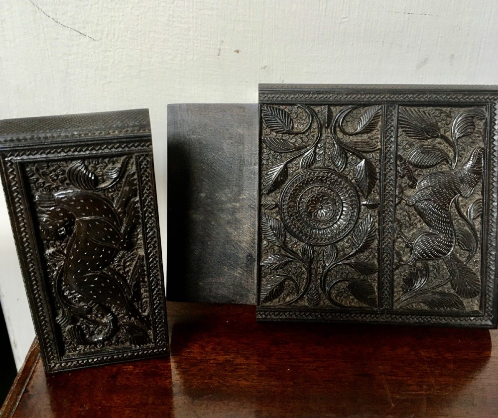 A rectangular dark carved wood card case decorated with high-relief carvings of animals, foliage, and a central circular floral motif. View III