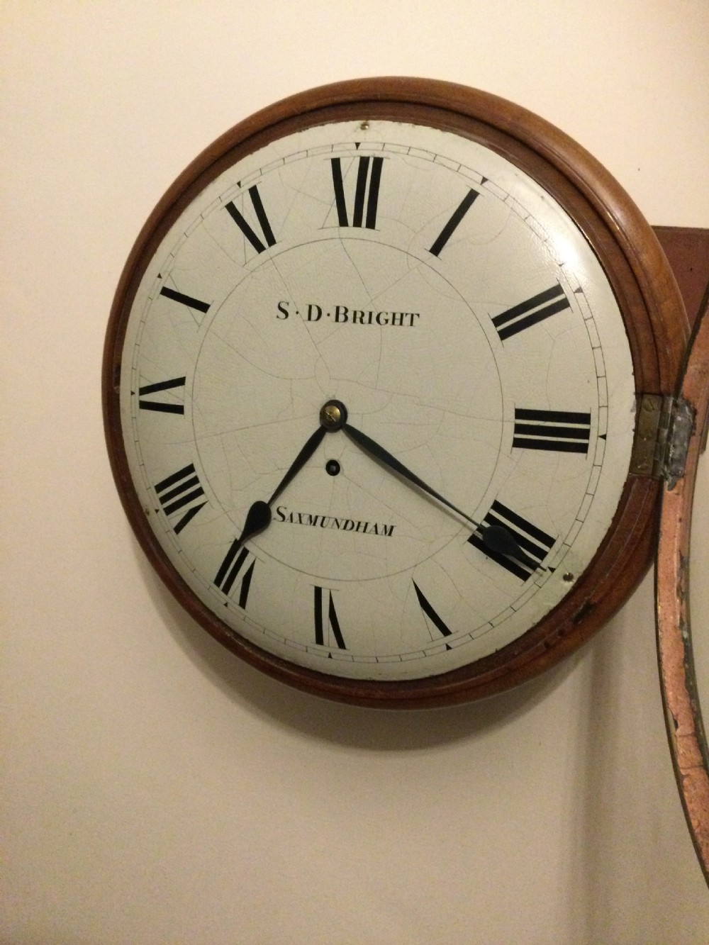 A circular Victorian dial wall clock featuring a warm mahogany bezel, an off-white painted dial with craquelure, black Roman numerals, and steel spade hands. View II