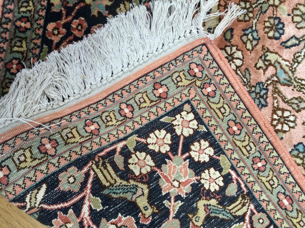 A rectangular hand-knotted Persian rug featuring a central terracotta field filled with a detailed Tree of Life and bird pattern framed by a dark navy floral border. View VIII