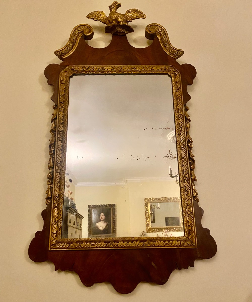 A Georgian Chippendale style mahogany wall mirror featuring a fret-cut frame topped with a carved gilded eagle finial and an inner gilded moulding. View III