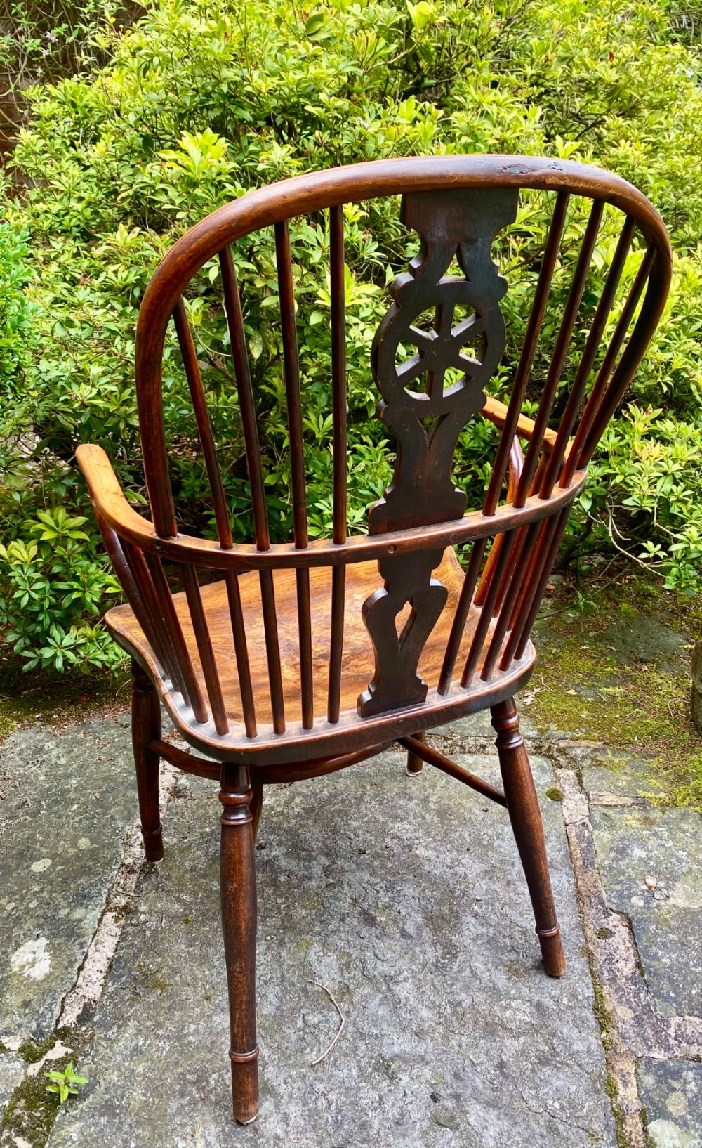 An antique yew wood Windsor armchair featuring a hoop back with a decorative wheelback splat, shaped saddle seat, and turned legs. View VII