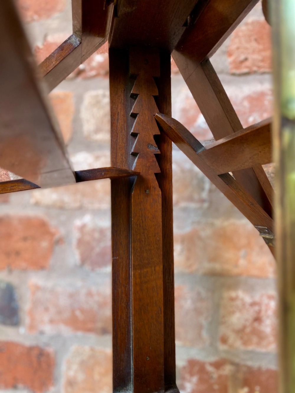 An antique mahogany duet music stand featuring double lyre-shaped rests, an adjustable brass stem, and a turned pedestal base on tripod feet. View VI