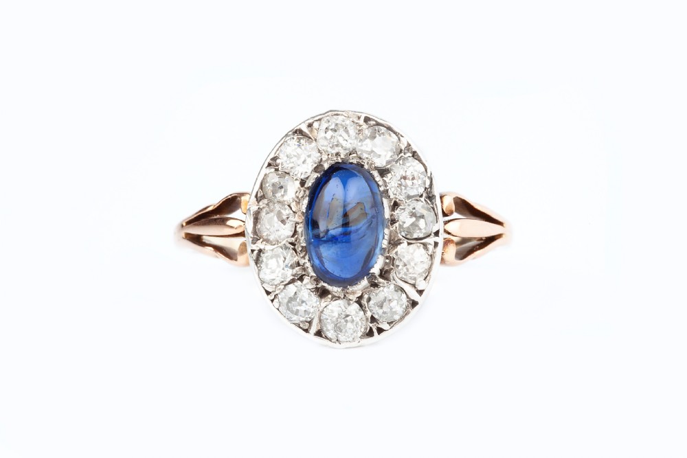A Natural Unheated Cabochon Sapphire and Diamond Ring