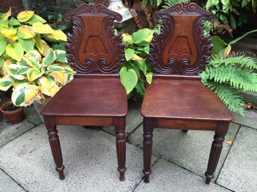 fig 1. Pair of early C19th George IV period carved mahogany hall chairs