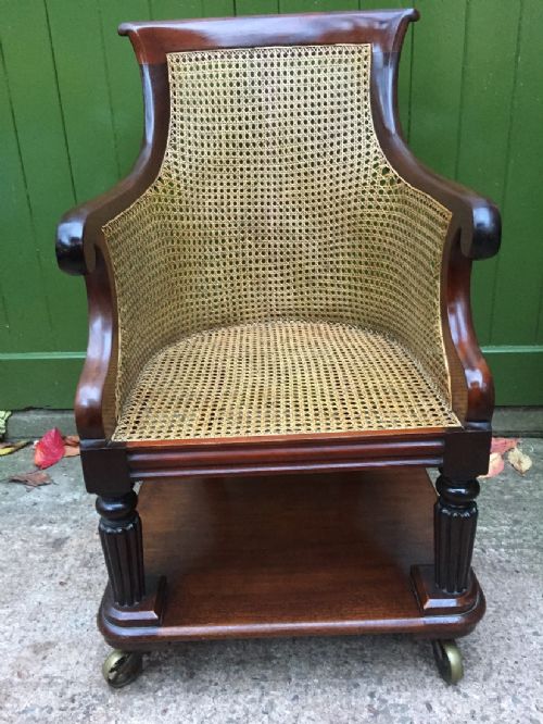 fig 1. Early C19th George IV period mahogany framed gentlemans bergere library or desk armchair of rare form .