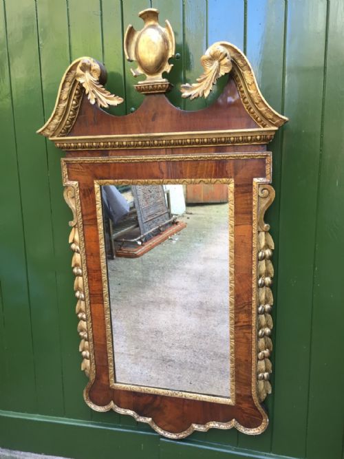 fig 1. C18th George II period walnut and carved 'parcel' gilt framed mirror of Palladian design .