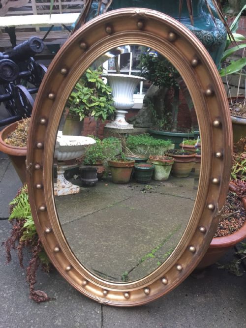 fig 1. Late C19th oval giltwood-framed mirror in the Regency style.