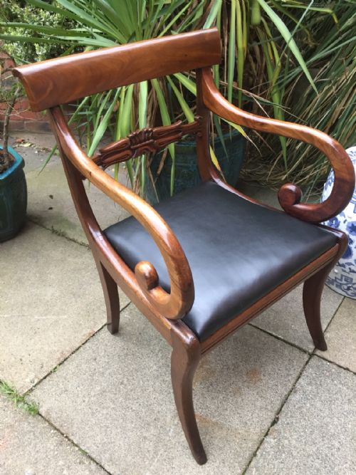 fig 1. Early C19th Regency period mahogany sabre-leg scrolled-arm desk or library chair of broad proportions.
