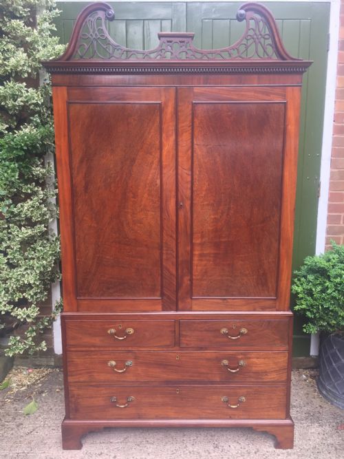 fig 3. Rare George III Chippendale period and design padouk and mahogany linen-press or wardrobe with open fret-work