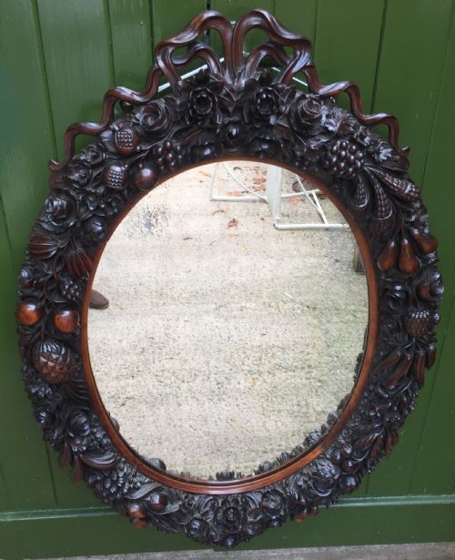 fig 1. Exceptional mid C19th Indo-Portuguese carved rosewood or padauk framed oval mirror.