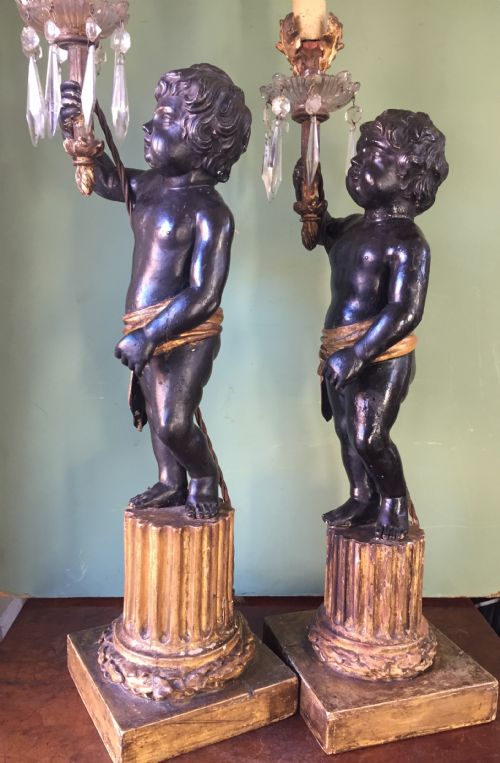 fig 1. Pair of early C19th Italian carved wood amorini or cherubs modelled as lamps raised on truncated fluted column bases.