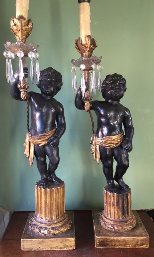 fig 2. Pair of early C19th Italian carved wood amorini or cherubs modelled as lamps raised on truncated fluted column bases.