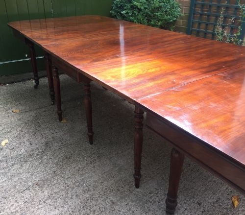 fig 2. A Regency mahogany extending dining table with turned legs and brass castors.