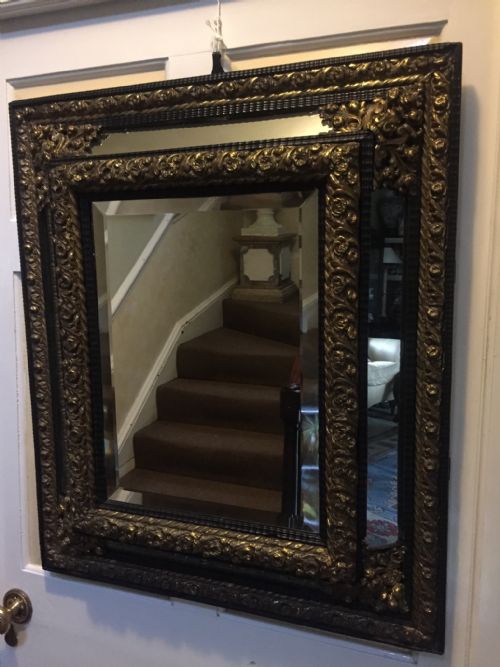 fig 1. C19th Flemish ebony and repousse brass 'cushion' mirror of C17th design.