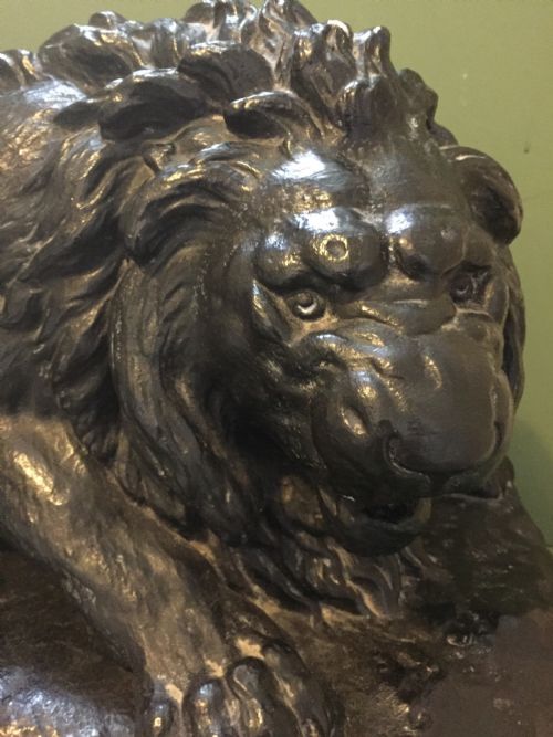fig 2. A nineteenth-century bronzed plaster sculpture depicting a prowling lion mounted on an octagonal base.