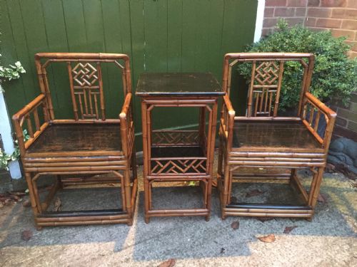 fig 1. Decorative pair of early C20th Chinese polished bamboo and lacquer armchairs and table in the C18th manner .