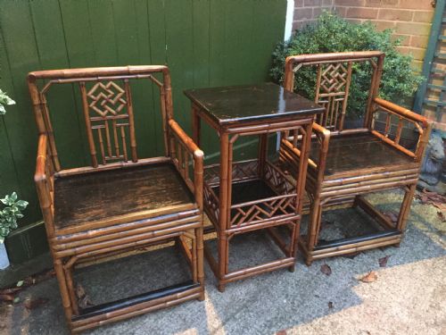 fig 3. Decorative pair of early C20th Chinese polished bamboo and lacquer armchairs and table in the C18th manner .