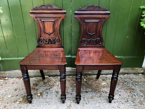 fig 1. Pair of early C19th George IV period mahogany hall chairs of Grecian revival design.
