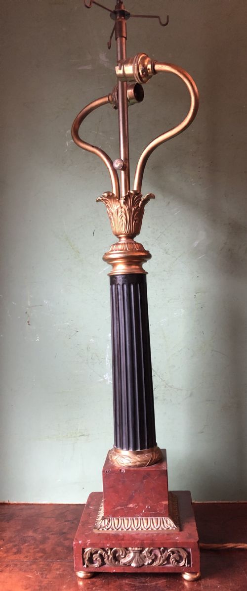 fig 2. Late 19th-century French Empire style table lamp featuring a dark patinated bronze fluted column on a red marble base with gilded ormolu accents.